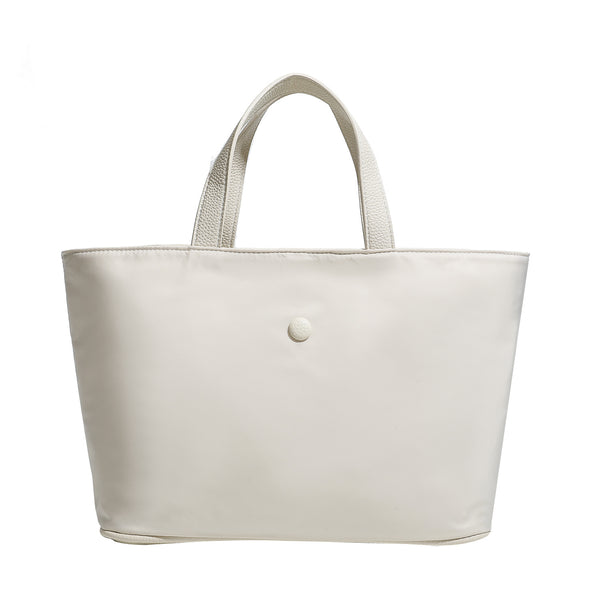 Structured lightweight nylon tote bag with textured double top handles and snap-button front detail, detail view 5