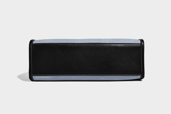 Structured rectangular tote satchel in denim-look fabric with dark trim, knotted front strap hardware, and detachable, detail