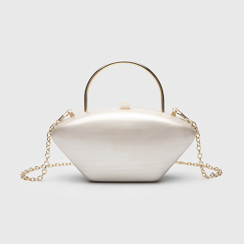 Shell-shaped pearlescent top-handle clutch bag with arched gold-tone metal handle and gold chain strap, detail view 6
