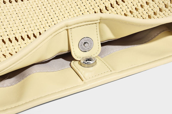 Handwoven open-weave shoulder bag with leather-look trim, knotted adjustable strap, and clip-on sunglasses sleeve pouch