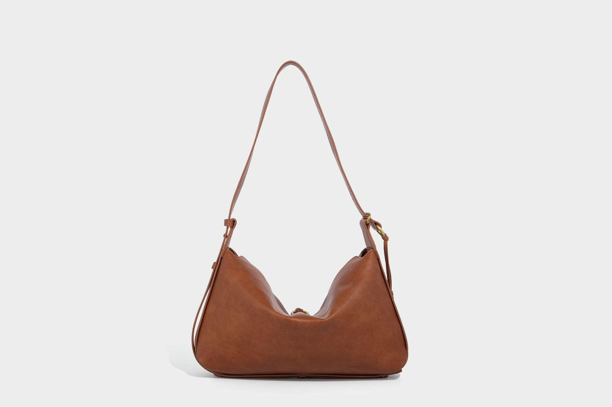 Slouchy brown leather-look shoulder bag with knotted drawcord tie closure, gold-tone ring hardware, and long adjustable