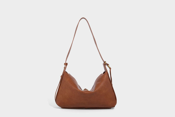 Slouchy brown leather-look shoulder bag with knotted drawcord tie closure, gold-tone ring hardware, and long adjustable