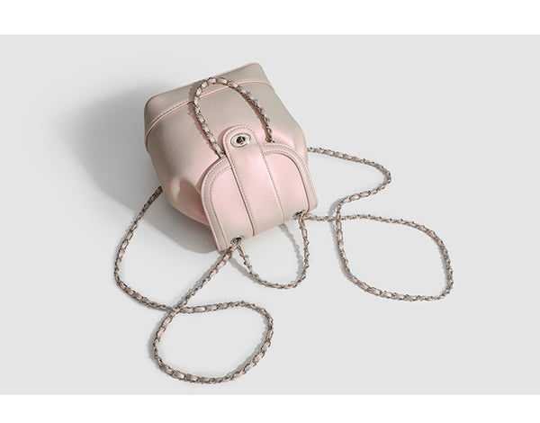 Small pearl-gloss backpack handbag with woven silver chain straps and turn-lock flap closure, detail view 8