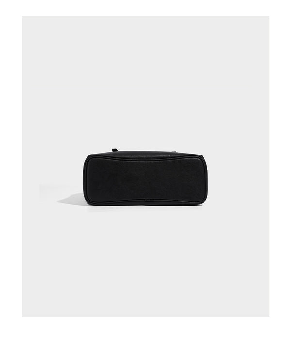 Structured dome-shaped shoulder bag with leather-look finish, top zipper closure, dual adjustable slim straps, and, detail