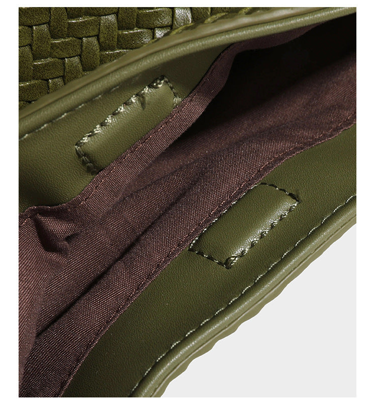 Olive green woven leather-look bucket bag with braided crossbody strap, knotted adjustment, and gold-tone tassel charm with