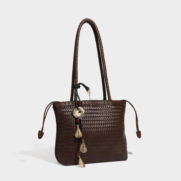 Structured woven leather-look tote bag in dark brown with long shoulder straps, side drawstring ties, and gold filigree