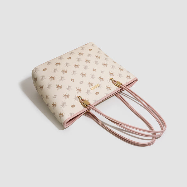 Cream structured tote bag with allover horse-and-crest print, blush-pink leather-look double shoulder straps, gold-tone