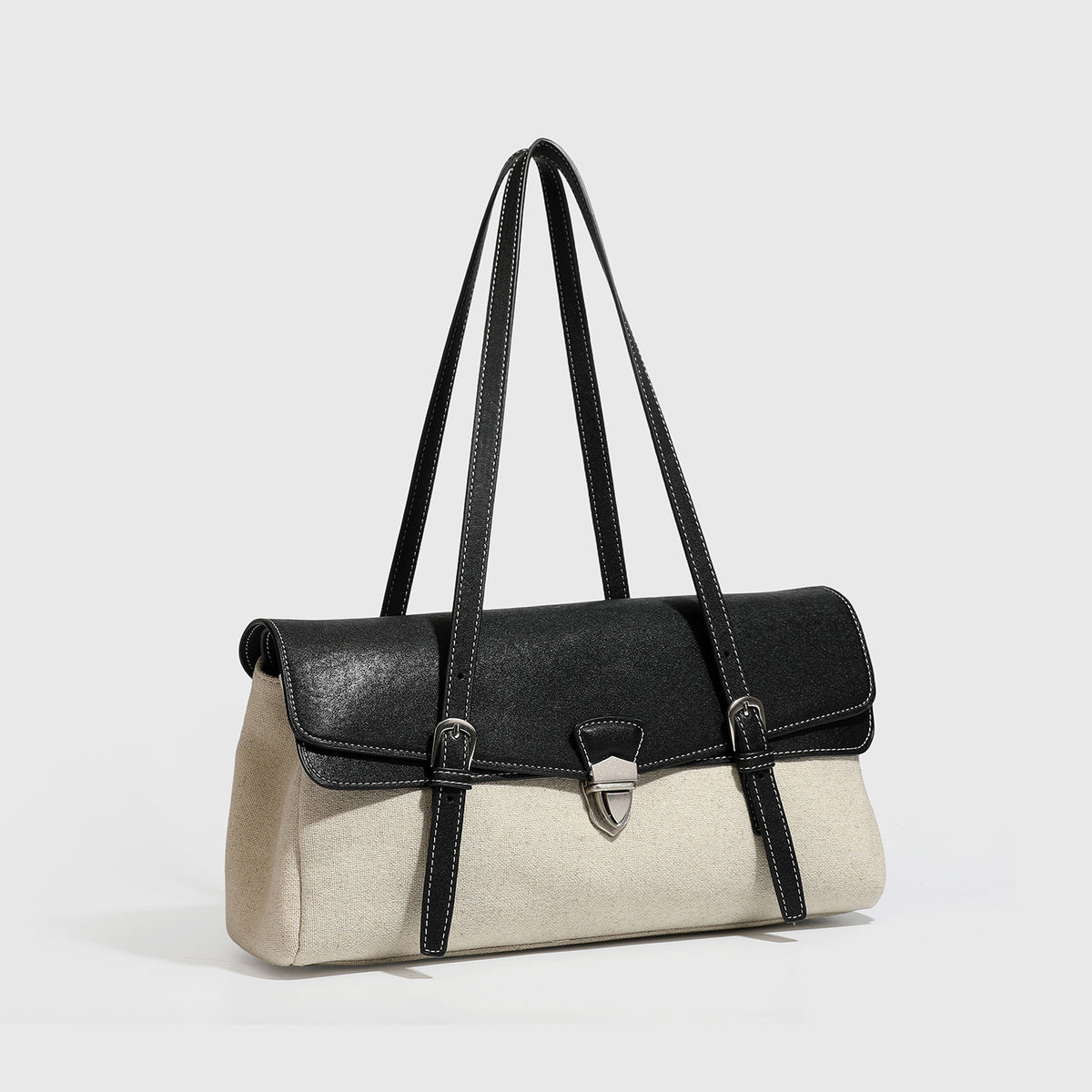 Strukturierte zweifarbige Schultertasche mit schwarzer Klappe in Lederoptik, cremefarbenem Korpus mit Webstruktur, silberfarbenem Drehverschluss und Doppel