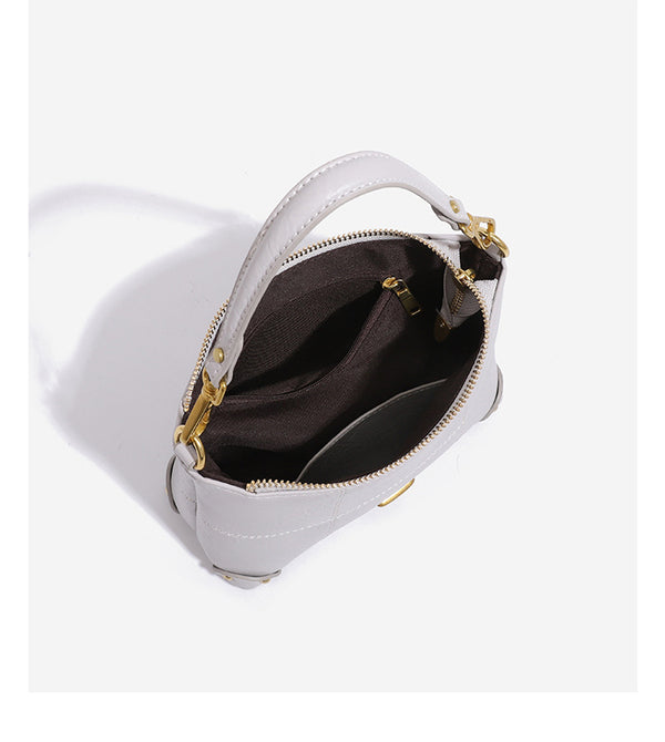 Small soft-structured shoulder bag with curved zip closure, stitched panel detailing, and gold-tone hardware, detail view 15