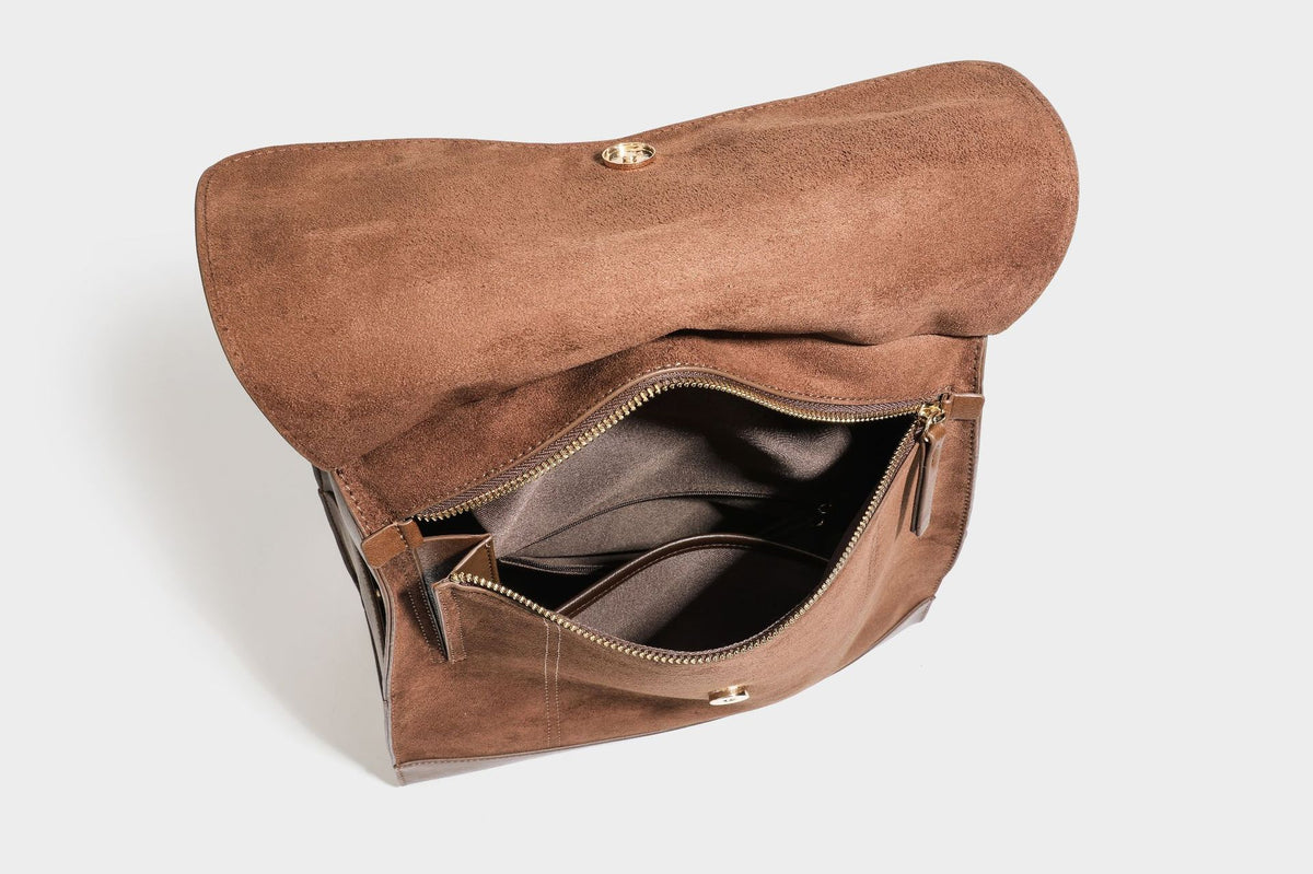 Structured suede-look convertible backpack handbag with flap closure and gold-tone emblem hardware in chocolate brown, detail