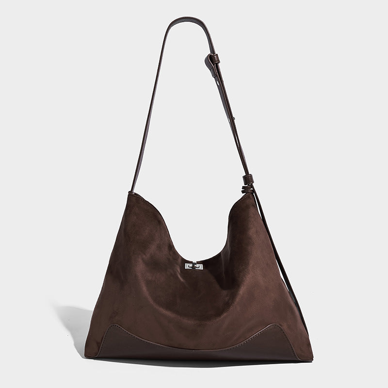 Dark brown slouchy hobo bag with matte suede-look body, smooth leather-look base trim, adjustable shoulder strap, and, detail