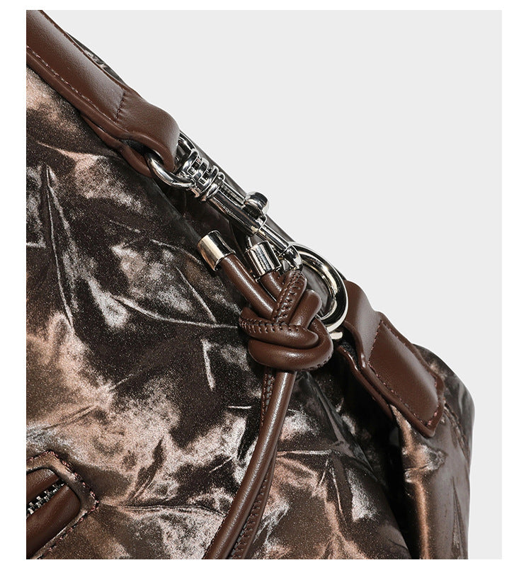 Slouchy hobo shoulder bag in crinkled metallic brown leather-look finish with braided rope knots, silver-tone hardware
