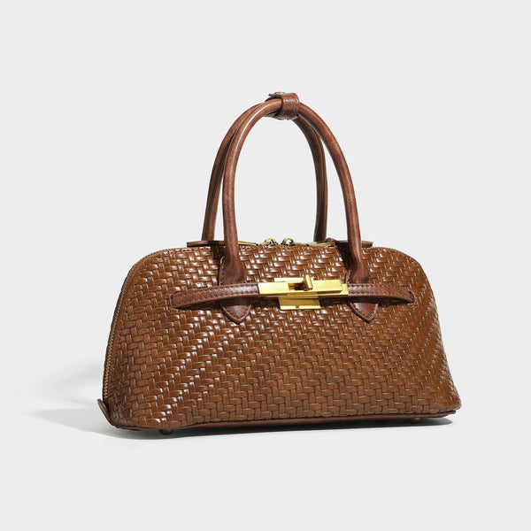 Structured woven-embossed leather-look satchel with dual rolled top handles, gold-tone turn-lock closure, and detachable