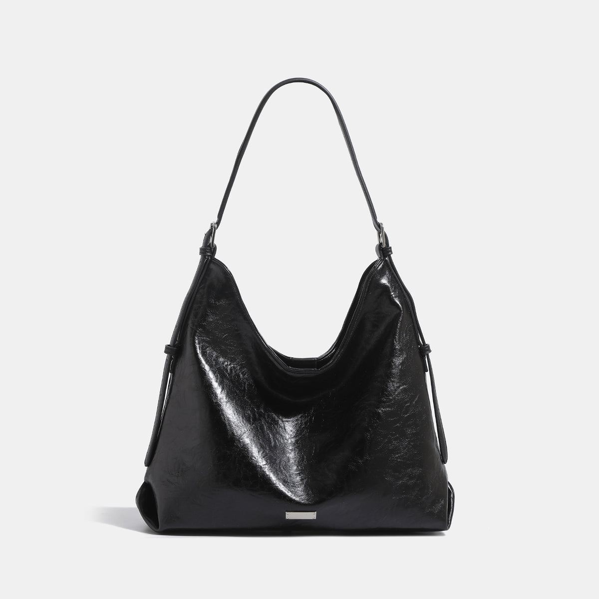 Slouchy hobo shoulder bag with glossy wrinkled leather-look finish, adjustable strap, and snap closure, front view