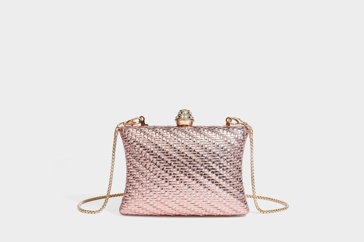 Small structured rectangular metallic woven-texture clutch bag with jeweled knob clasp and gold-tone chain strap, detail view