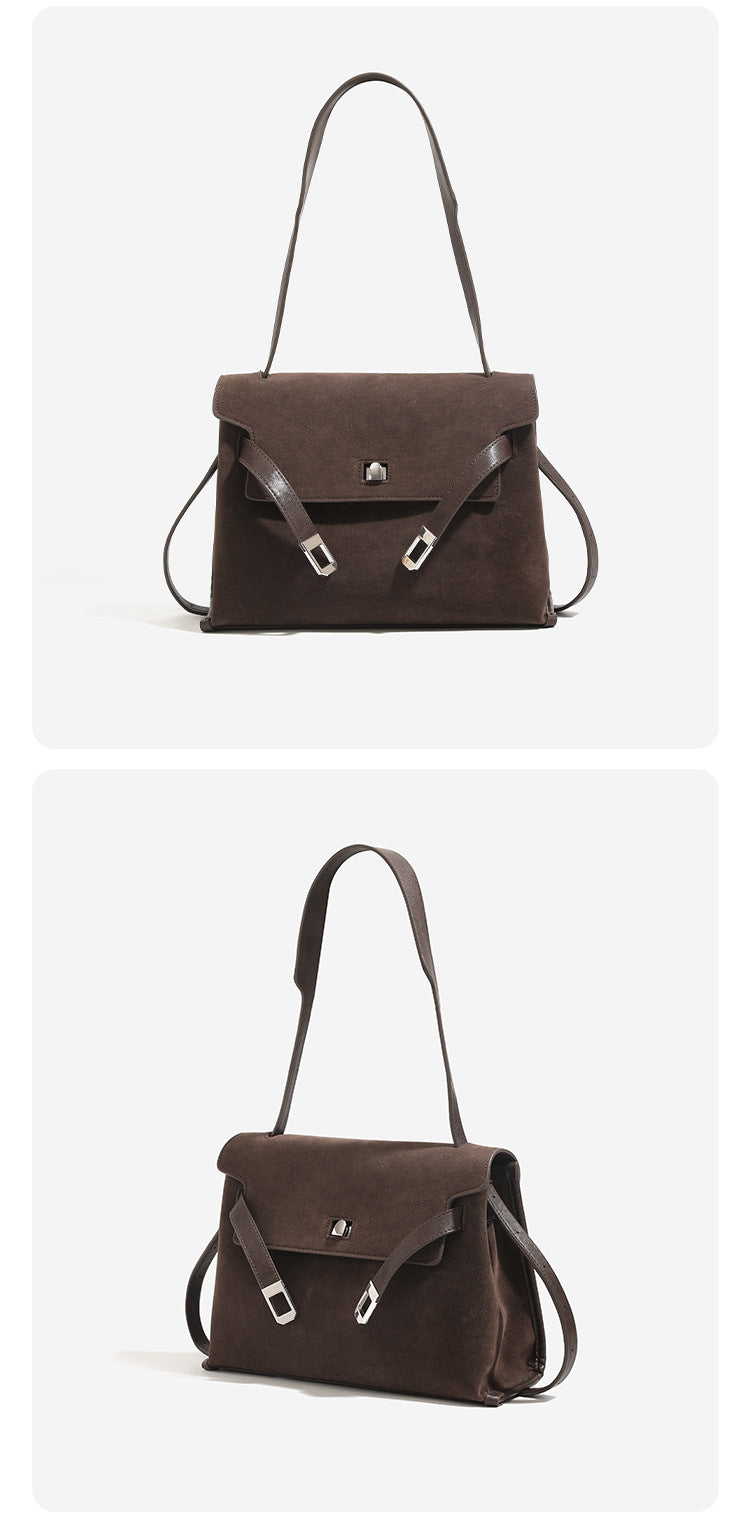 Structured trapezoidal flap satchel bag with silver-tone turn-lock clasp, decorative front strap tabs, gusseted sides, and