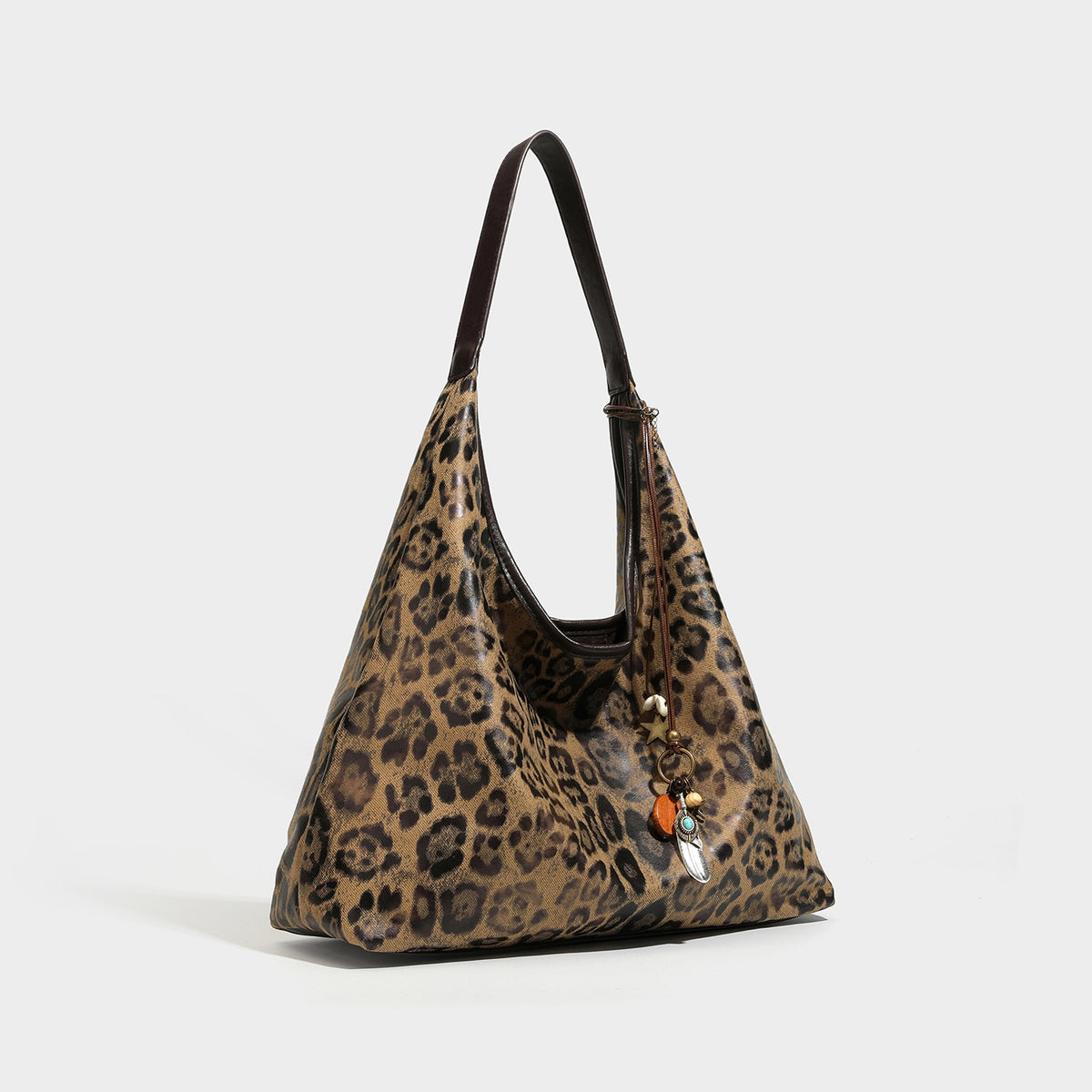 Slouchy leopard-print hobo tote bag in tan and brown with dark brown leather-look strap and dangling bead charm hardware