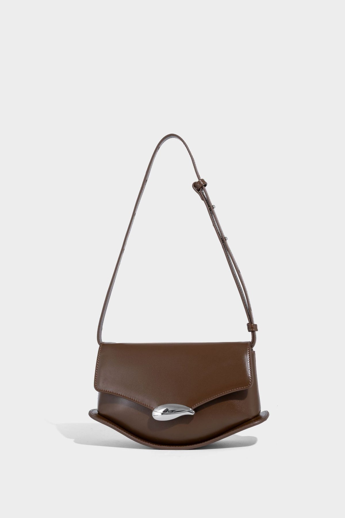 Small structured saddle bag with glossy leather-look finish, angular flap front, silver-tone metal clasp, and slim