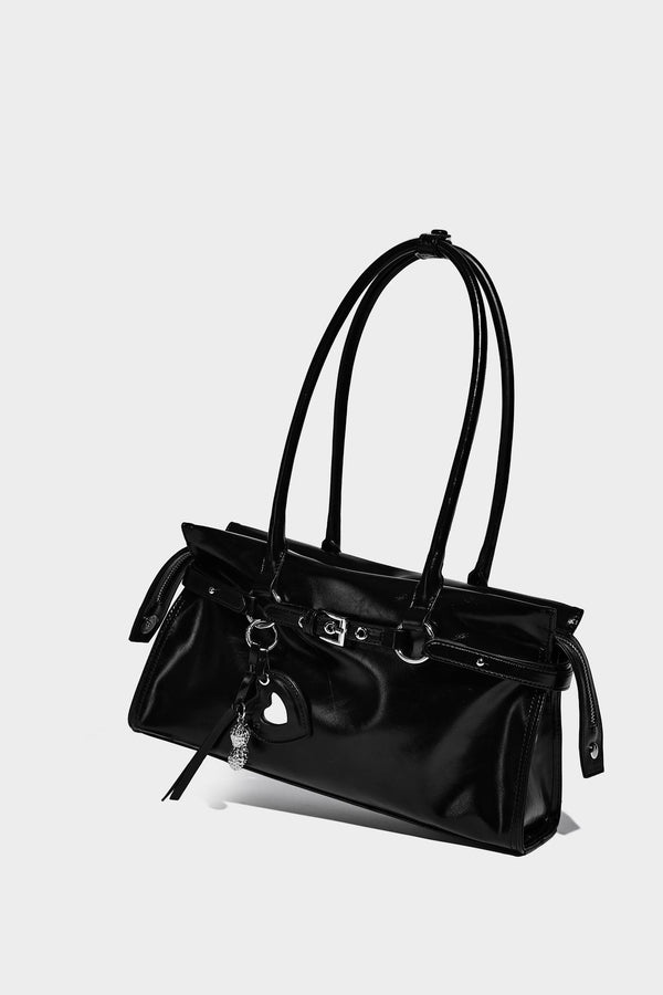Structured rectangular glossy tote shoulder bag with belt buckle front strap and dangling charm hardware, detail view 10