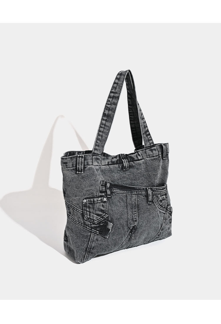 Large washed denim tote bag with jeans-style patch pocket and riveted seam detailing, double shoulder straps, open top