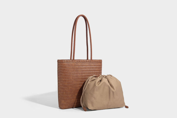 Structured woven herringbone tote bag with braided double shoulder handles in tan brown, shown with matching drawstring