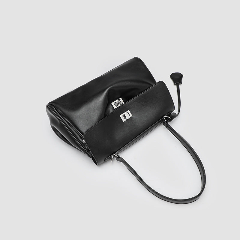 Structured black leather-look flap satchel bag with silver turn-lock hardware and top handle, detail view 4