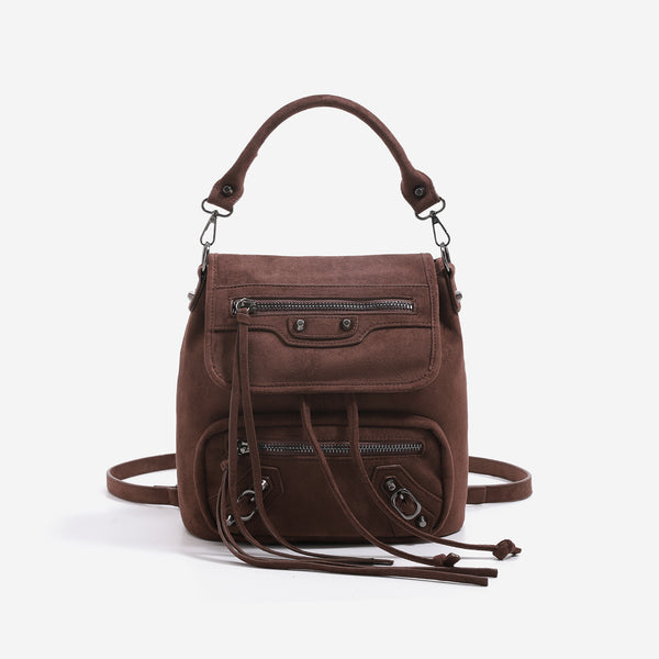Mini flap backpack handbag with silver stud hardware, front zip pockets, and drawstring tassels, detail view 8