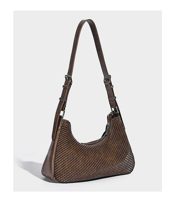 Woven crescent hobo shoulder bag with smooth side panels, zip-top closure, silver-tone charm hardware, and adjustable, detail