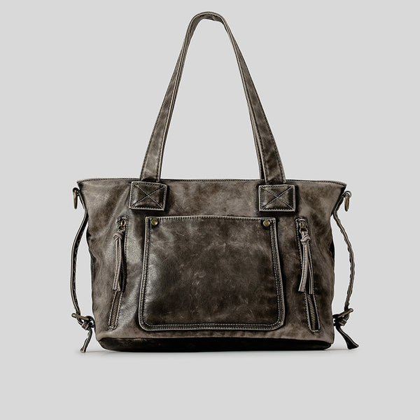 Distressed leather-look convertible tote bag with dual top handles, front zip and patch pockets, and adjustable shoulder