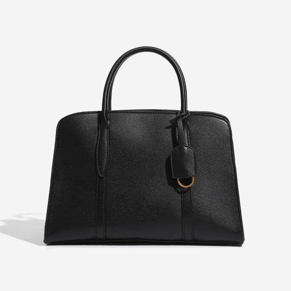 Structured trapezoid Boston satchel bag with dual top handles, gold-tone lock charm, and top zip closure, detail view 7
