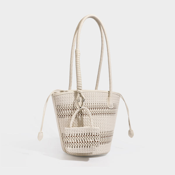 Light blue open-weave woven bucket tote bag with long braided shoulder straps, drawstring side ties, and attached mini pouch