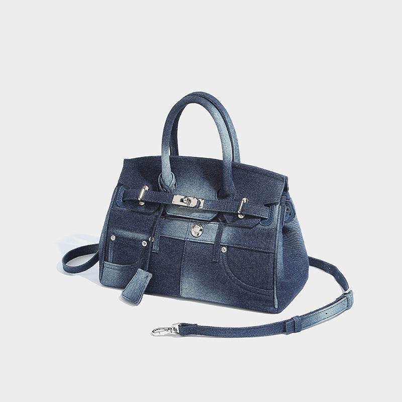 Strukturierte Satchel aus gewaschenem Denim im Patchwork-Design mit gerollten Tragegriffen, Überschlag mit Drehverschluss, aufgesetzten Vordertaschen und, Detail