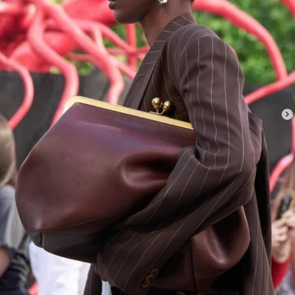 Oversized kiss-lock frame handbag with gold-tone metal clasp and smooth leather-look finish, detail view 3