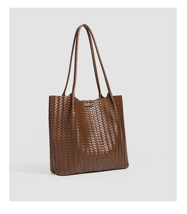 Large black basket-weave leather-look tote bag with long braided shoulder straps and matching woven zip pouch, detail view 18