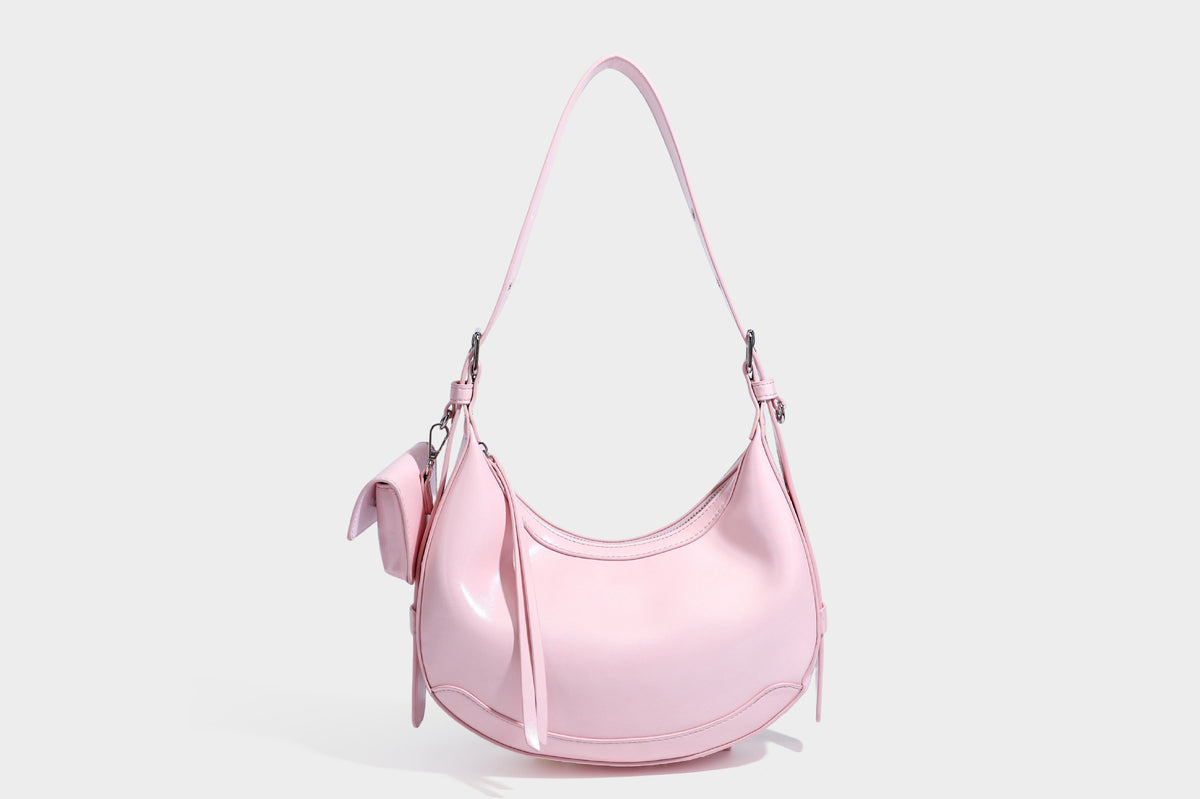 Glossy leather-look crescent hobo shoulder bag with dark contrast trim, silver-tone hardware, and attached mini flap pouch