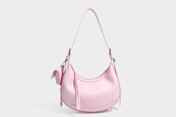 Glossy leather-look crescent hobo shoulder bag with dark contrast trim, silver-tone hardware, and attached mini flap pouch