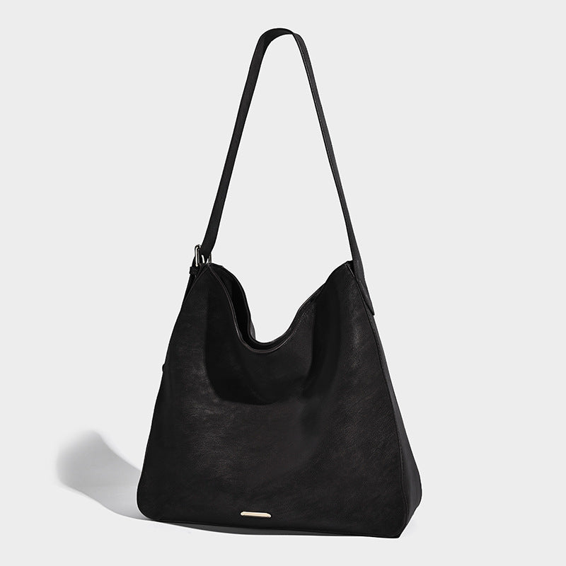 Large slouchy hobo shoulder bag in matte leather-look finish with adjustable strap and gold-tone bar hardware, detail view 7