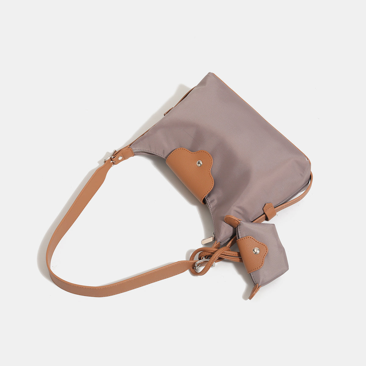 Slouchy hobo shoulder bag in smooth fabric with leather-look tan trim, zip-top closure, adjustable strap, and detachable
