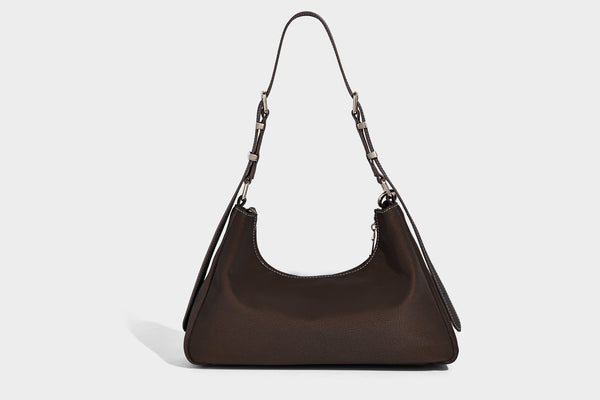 Crescent hobo shoulder bag in pebbled leather-look finish with top zipper, adjustable strap, gold-tone ring hardware, and