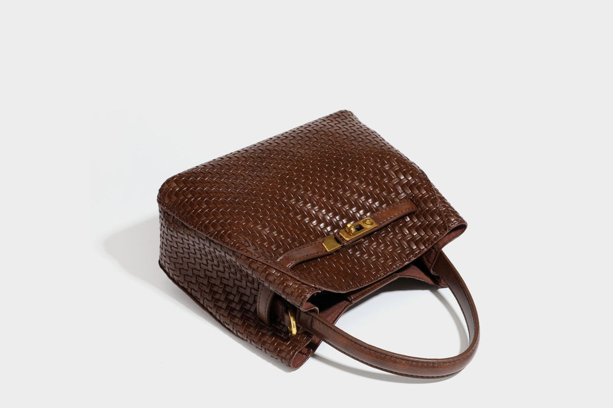 Structured woven leather-look bucket bag with gold-tone turn-lock hardware and detachable shoulder strap, detail view 39
