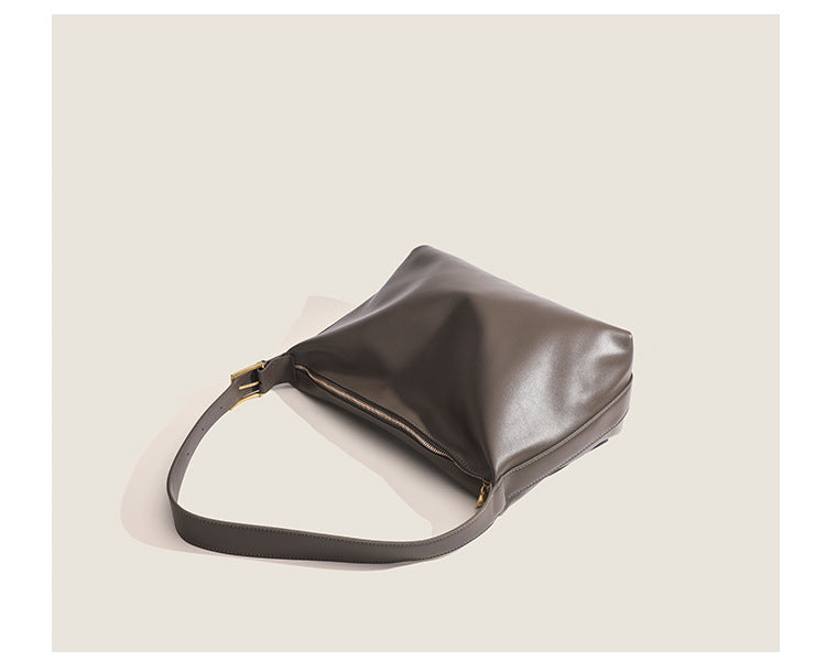 Large slouchy hobo shoulder bag in smooth leather-look finish with single long strap and gold-tone zip closure, detail view