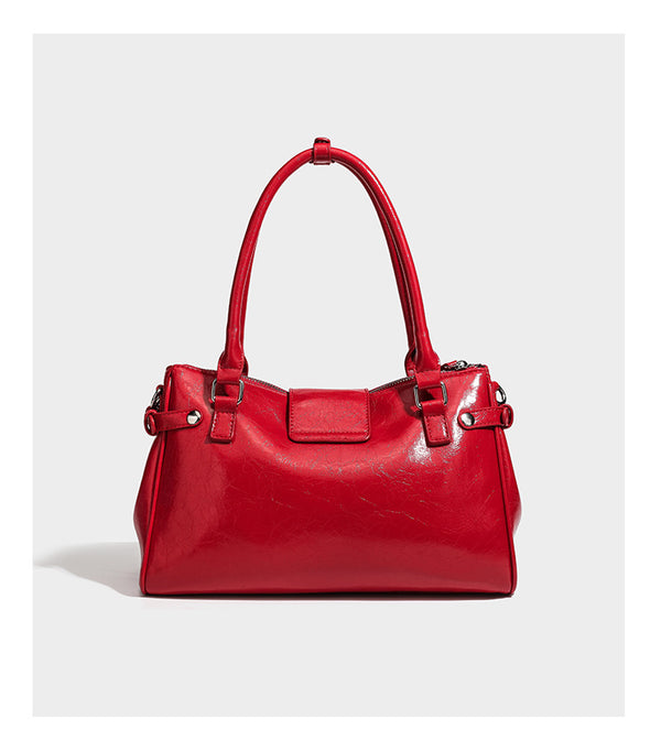 Structured glossy crinkled leather-look satchel with double top handles, front metal-plaque tab, silver-tone hardware, and