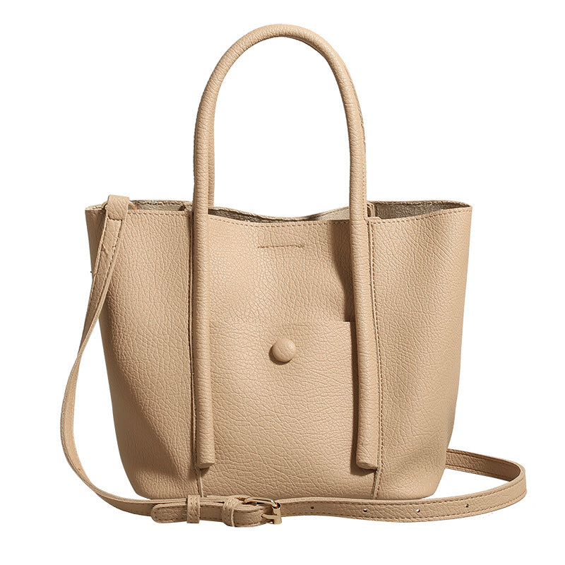 Structured pebbled matte tote bag with front snap pocket, dual top handles, and detachable zip pouch in almond beige, detail