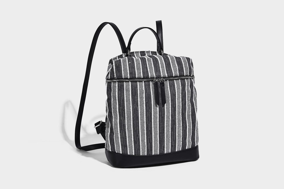Small structured striped fabric backpack handbag with cream leather-look trim, top handle, and silver-tone hardware, detail
