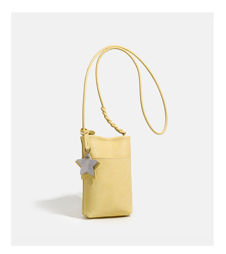 Small vertical textured mini crossbody phone bag with long braided cord strap and silver-toned star charm, detail view 17