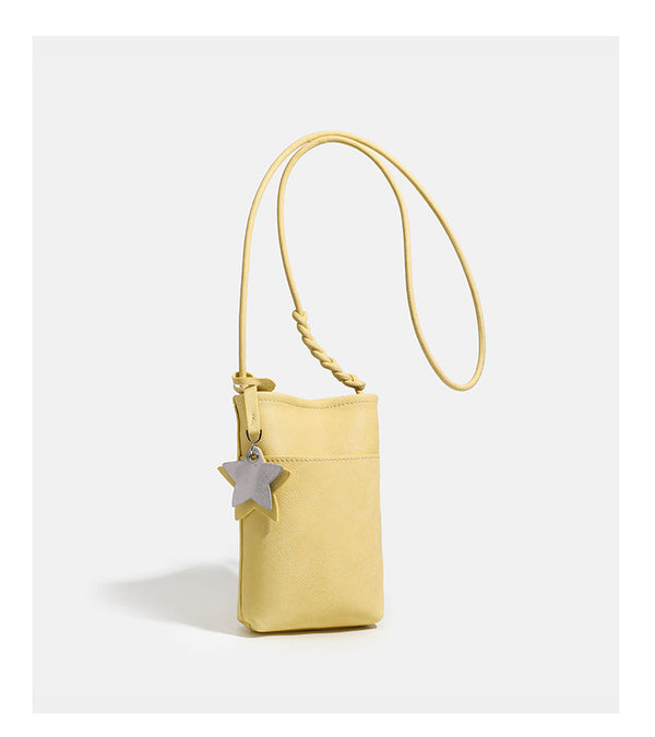 Small vertical textured mini crossbody phone bag with long braided cord strap and silver-toned star charm, detail view 17