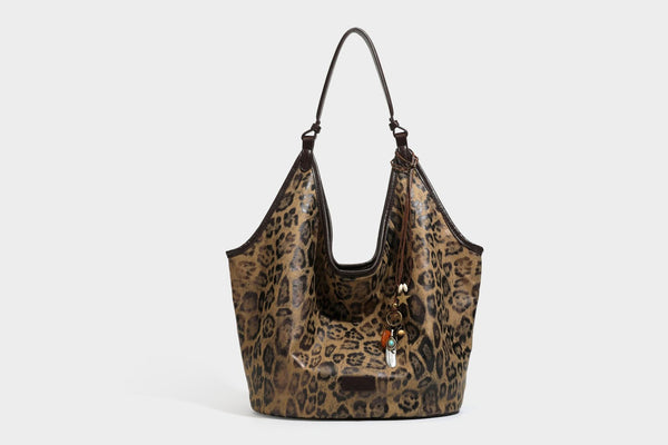 Large slouchy leopard-print shoulder tote bag with glossy tan-and-brown finish, dark brown leather-look trim, single