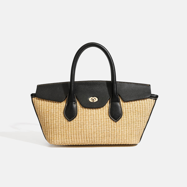 Structured tan woven straw tote bag with black leather-look trim, twin rounded top handles, gold-tone turn-lock front flap