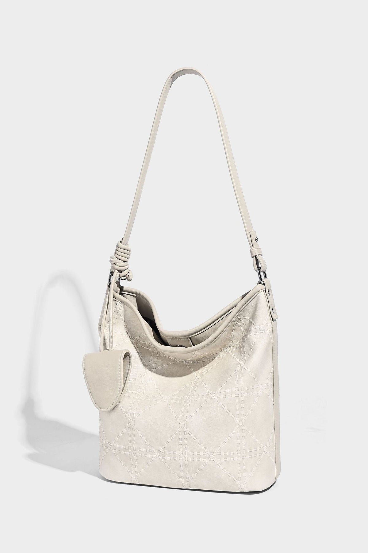 Diamond-quilted leather-look bucket shoulder bag with knotted strap accent and attached mini pouch, detail view 22