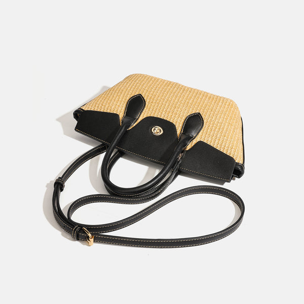 Structured tan woven straw tote bag with black leather-look trim, twin rounded top handles, gold-tone turn-lock front flap